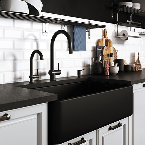 A black kitchen faucet paired with black kitchen accessories in a black-and-white kitchen.